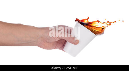 Hand pouring coffee or cola from a white plastic cup. Isolated on white background. Stock Photo