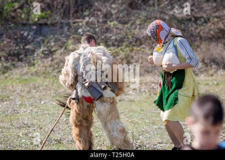 VARVARA, BULGARIA - MARCH 24, 2019: Moment from National Festival Dervish Varvara presents traditions of Bulgarian Kuker Games. Two dressed up male pa Stock Photo