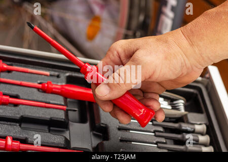 Screwdriver in the hand Stock Photo