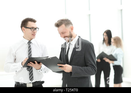close up. smiling colleagues discuss business documents. business concept Stock Photo