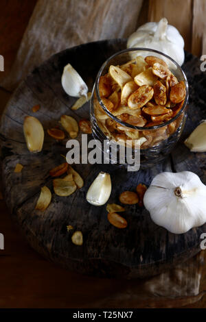 Photo of toasted peanuts and fried garlic chips on a glass Stock Photo