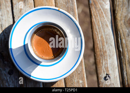 Cup of hot Indian style tea  or chai on wooden desk in Rajkot, Gujarat, India Stock Photo