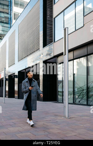 Spain, Barcelona, young man using mobile phone in the city Stock Photo