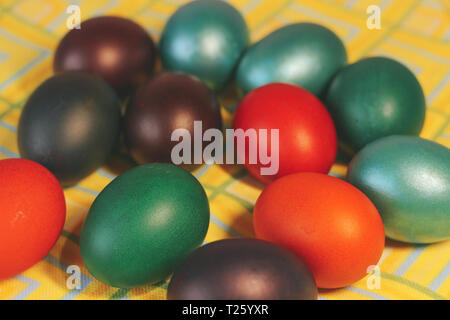 Multicolored painted eggs in the basket close up. Stock Photo