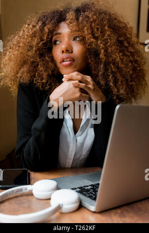 Young woman with laptop in a cafe Stock Photo