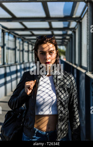 Portrait of young woman standing on a bridge Stock Photo