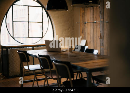 Laptop on table in wooden conference room Stock Photo