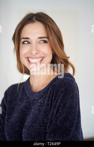 Happy young woman looking sideways Stock Photo