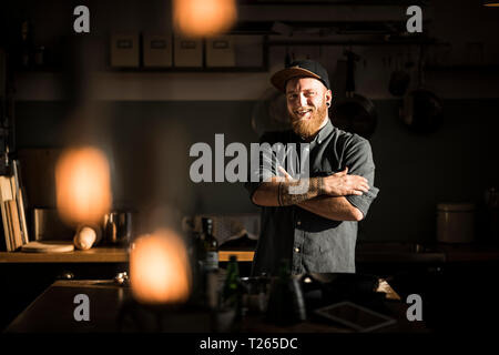 Proud hobby chef standing in his kitchen, with arms crossed Stock Photo