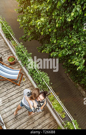Young affectionate couple dancing on their balcony Stock Photo