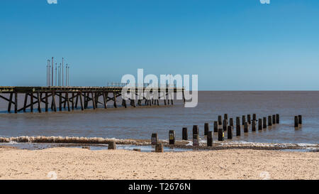 North Sea coast in Kirkley, Lowestoft, Suffolk, England, UK with the Claremont Pier and a wave breaker Stock Photo