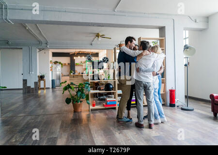 Business team huddling in loft office Stock Photo