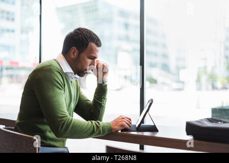 Business man using tablet in cafe Stock Photo
