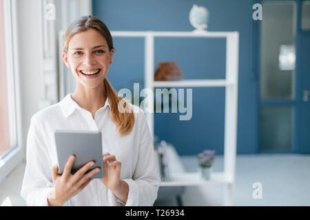 Young woman using digital tablet Stock Photo