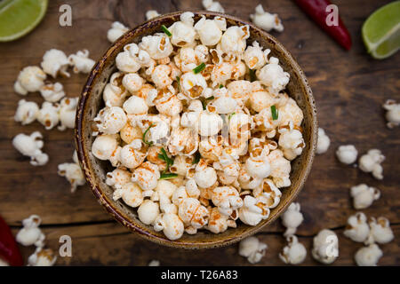 Bowl of popcorn flavoured with chili and lime Stock Photo