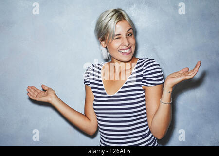 Cheaky young woman making funny faces Stock Photo