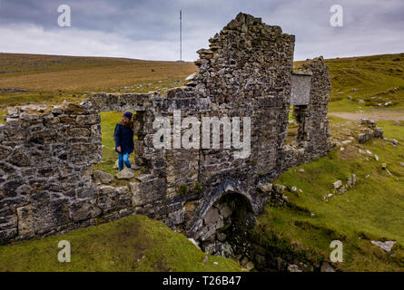 Couple look out of the window of a ruin on Dartmoor National Park, Devon, UK. Stock Photo