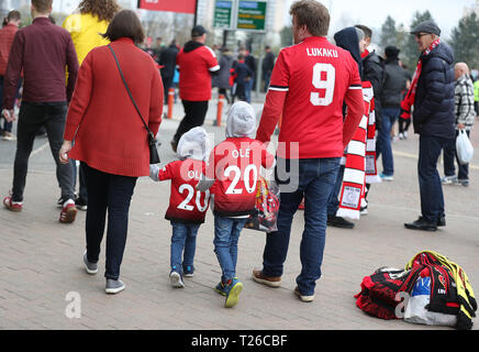 Young Manchester United fans make their way to stadium prior to the Premier League match at Old Trafford, Manchester. Stock Photo