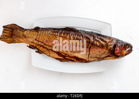 Smoked trout fish on a dark background Stock Photo