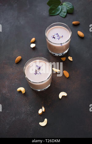 Traditional Indian drink, Holi festival food, Thandai Sardai milk drink with nuts, spices on dark  background, copy space. Stock Photo