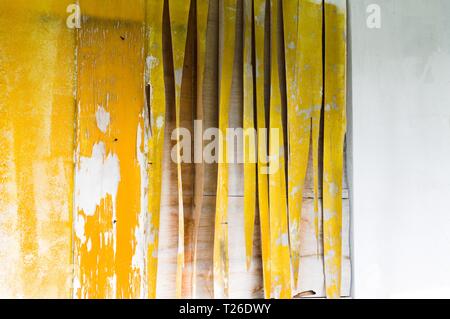 Yellow painted panel in front of a wooden door (Ari Atoll, Maldives) Stock Photo