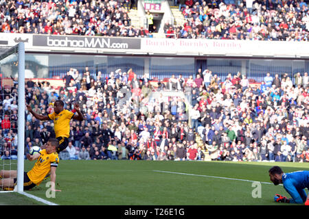 Wolverhampton Wanderers' Conor Coady (in net at front) puts the ball in to the back of his own net for an own goal and the first goal of the game during the Premier League match at Turf Moor, Burnley. Stock Photo