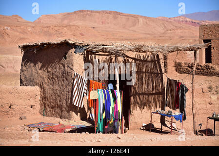 Traditional moroccan hut with colorful clothes hanging outside. Ait Benhaddou, Souss-Massa-Draa, Morocco Stock Photo