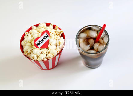 Top view of popcorn bag and glass of drink with ices isolated on white background Stock Photo