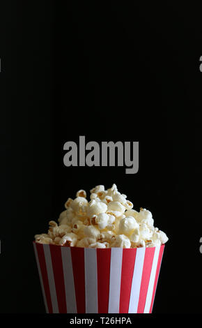 Popcorn bag isolated on dark background Stock Photo