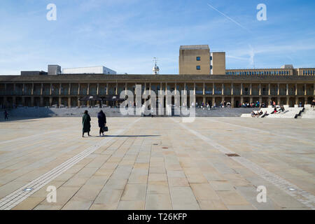 View looking across the plaza square is towards the West wall / Westgate / West Gate of the quadrangle of restored The Piece Hall. Sunny / sun & blue sky. Halifax, England UK Stock Photo