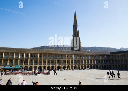 The Piece Hall with Square Chapel church spire behind the East Wall in the background. Sunny / sun & blue sky. Halifax, West Yorkshire, UK. (106) Stock Photo