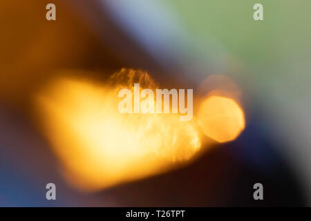 Colorful patch, light reflections, bokeh - diffracted sun rays in a beer bottle. Stock Photo