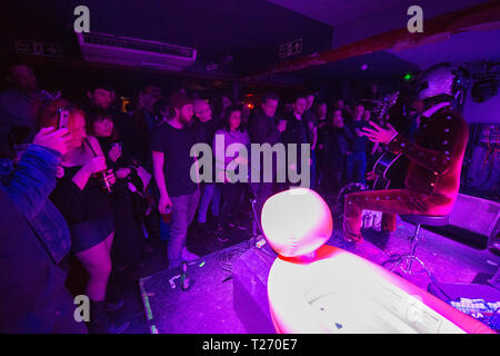 Glasgow, UK. 29 March 2019. Bob Log III, playing in concert at Broadcast in Glasgow.  Bob Log III is an American slide guitar one-man band based in Tucson, Arizona, and Melbourne, Australia. During performances, he plays old Silvertone archtop guitars, wears a full body human cannonball suit, and a helmet wired to a telephone receiver, which allows him to devote his hands and feet to guitar and drums.  His full name is Robert Logan Reynolds III Credit: Colin Fisher/Alamy Live News Stock Photo