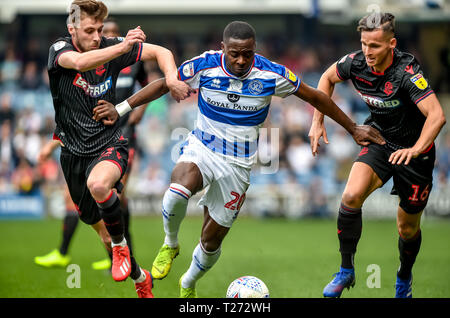 Loftus Road Stadium, London, UK. 30th March 2019. Bright Osayi-Samuel of Queens Park Rangers  with the ball being challenged by Joe Williams and Pawel Olkowski of Bolton Wanderers during the EFL Sky Bet Championship match between Queens Park Rangers and Bolton Wanderers at the Loftus Road Stadium, London, England on 30 March 2019. Photo by Phil Hutchinson.  Editorial use only, license required for commercial use. No use in betting, games or a single club/league/player publications.