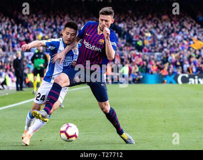 Barcelona, Spain. 30th Mar, 2019. FC Barcelona's Clement Lenglet (R) vies with Espanyol's Wu Lei during a Spanish league match between FC Barcelona and RCD Espanyol in Barcelona, Spain, on March 30, 2019. FC Barcelona won 2-0. Credit: Joan Gosa/Xinhua/Alamy Live News Stock Photo