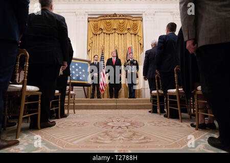 President Donald J. Trump stands with Trevor Oliver, son of Medal of Honor recipient United States Army Staff Sgt. Travis W. Atkins, Wednesday, March 27, 2019, in the East Room of the White House. United States Army Staff Sgt. Atkins is being honored posthumously for his conspicuous act of gallantry while in service June 1, 2007 in Iraq.  People:  President Donald Trump Stock Photo