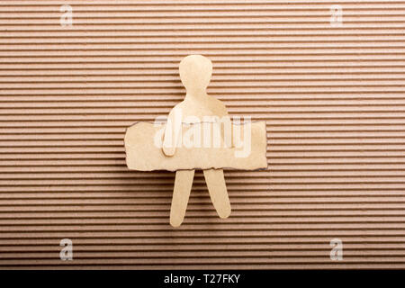 Paper man shape holding burnt note paper in hand Stock Photo