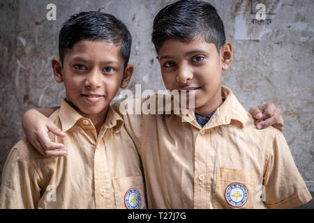 2 school boys in school uniforms are getting back home. They live in Geneva Camp, stranded Pakistanis enclave in Dhaka, Bangladesh. Stock Photo