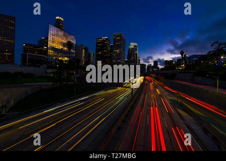 JANUARY 20, 2019, LOS ANGELES, CA, USA - California 110 South leads to downtown Los Angeles with streaked car lights at sunset Stock Photo