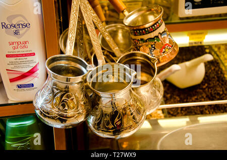 Istanbul, Turkey, March 07, 2019:traditional decorated Turkish coffee pots, hanging copper pots, various cezve on sale, close up Stock Photo