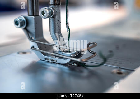 Professional sewing machine close-up. Modern textile industry. Stock Photo