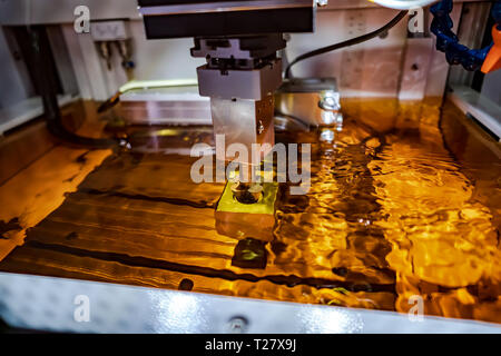Metalworking CNC Electrolysis milling machine. Cutting metal modern processing technology. Small depth of field. Warning - authentic shooting in chall Stock Photo