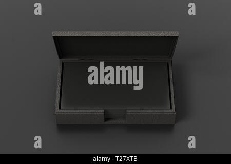 Black leather business card box holder with black business cards in stack on black leather background Stock Photo