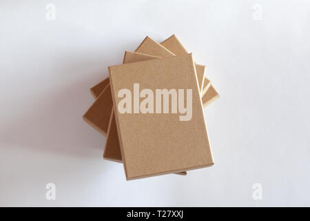 Stack of four blank closed carton boxes packaging isolated on white background. Stock Photo