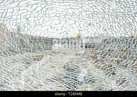 Broken smashed window pane in urban location Stock Photo