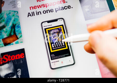 Paris, France - Mar 27, 2019: Apple News Plus demo website on iPad Pro showing National Grographic on the iPhone display Stock Photo