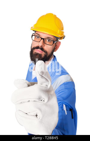 High angle portrait of serious bearded builder, foreman or repairman in the yellow helmet and glasses pointing his finger at you in working gloves. Is Stock Photo
