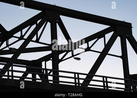 The silhouetted upper steel of the Iron Cove Bridge that joins the Sydney suburbs of Drummoyne and Rozelle over the upper reaches of Sydney harbour. Stock Photo