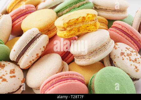 Heap of colorful macarons with various fillings. Close-up shot. Stock Photo