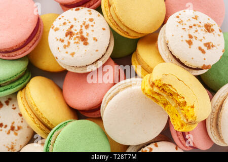 Heap of colorful macarons with various fillings. Overhead shot. Stock Photo